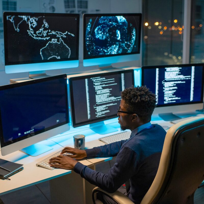 Man working at night in an office coding
