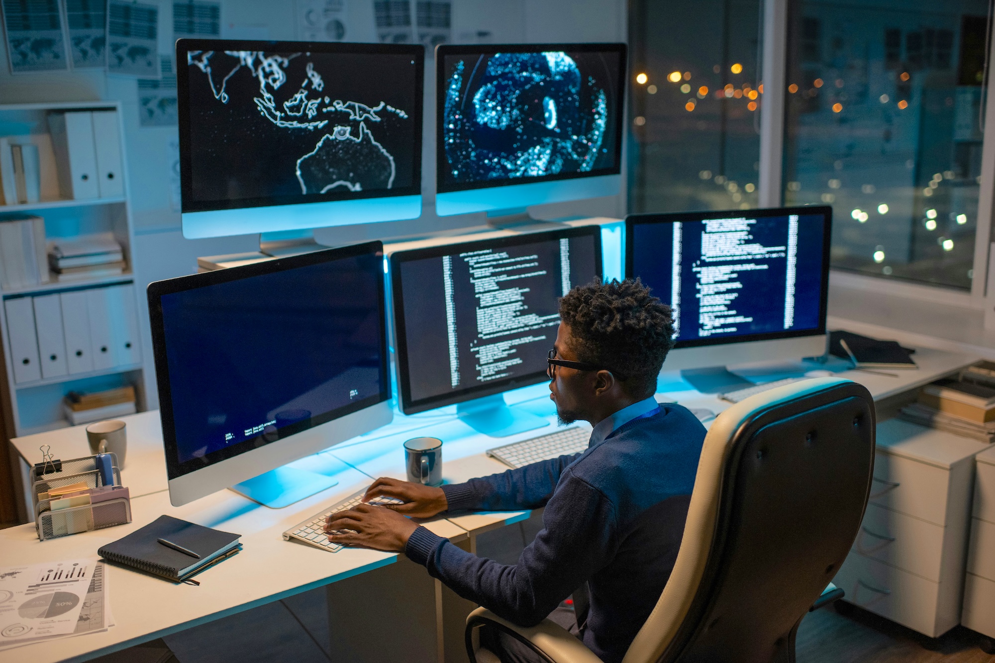 Man working at night in an office coding