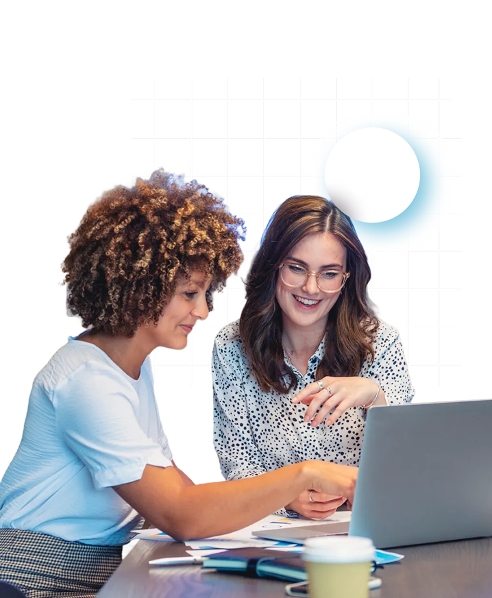 Two women working together on computer